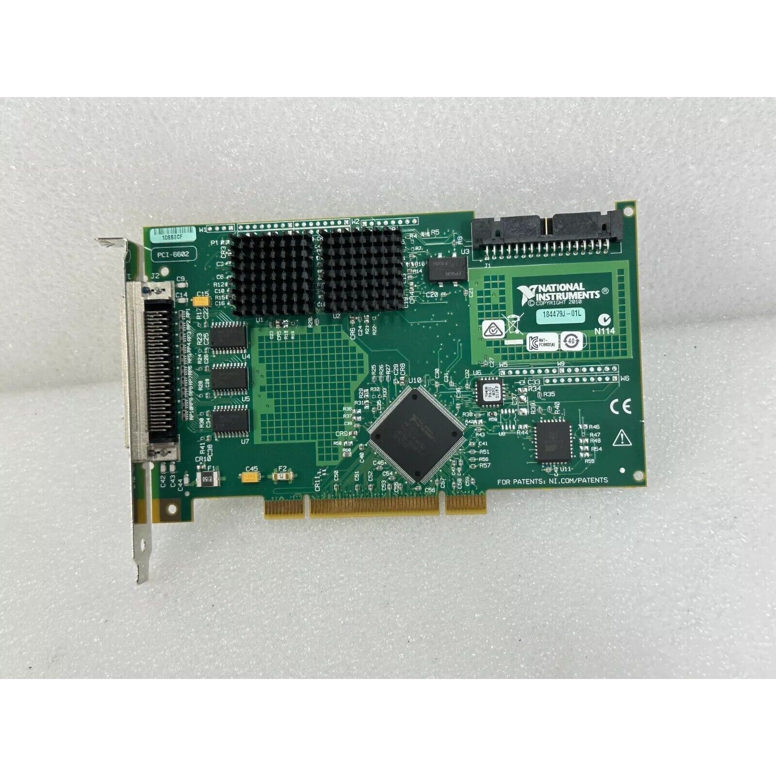 National Instruments PCI-6602 data acquisition card, green circuit board, black heatsink.