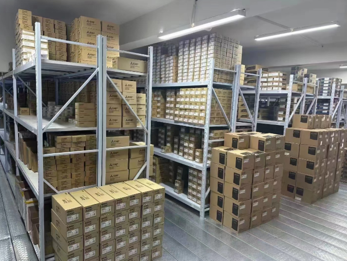 Warehouse storage of Mitsubishi MR-J2S-40A-S004 servo drives in boxes, industrial automation parts, ready for shipment.