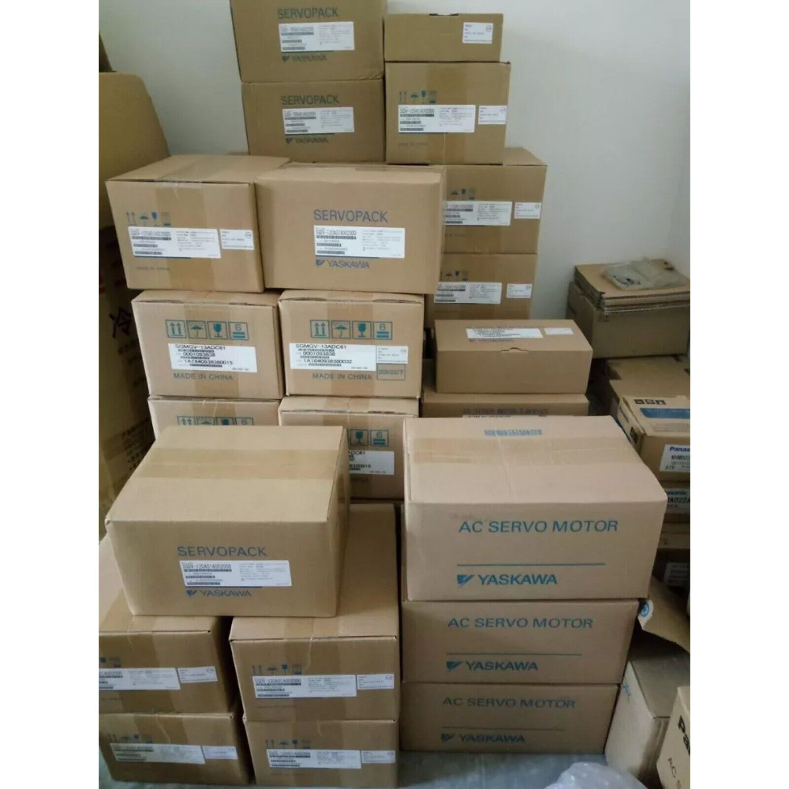 Yaskawa Servo Driver boxes, stacked, new industrial automation parts, expedited shipping available.