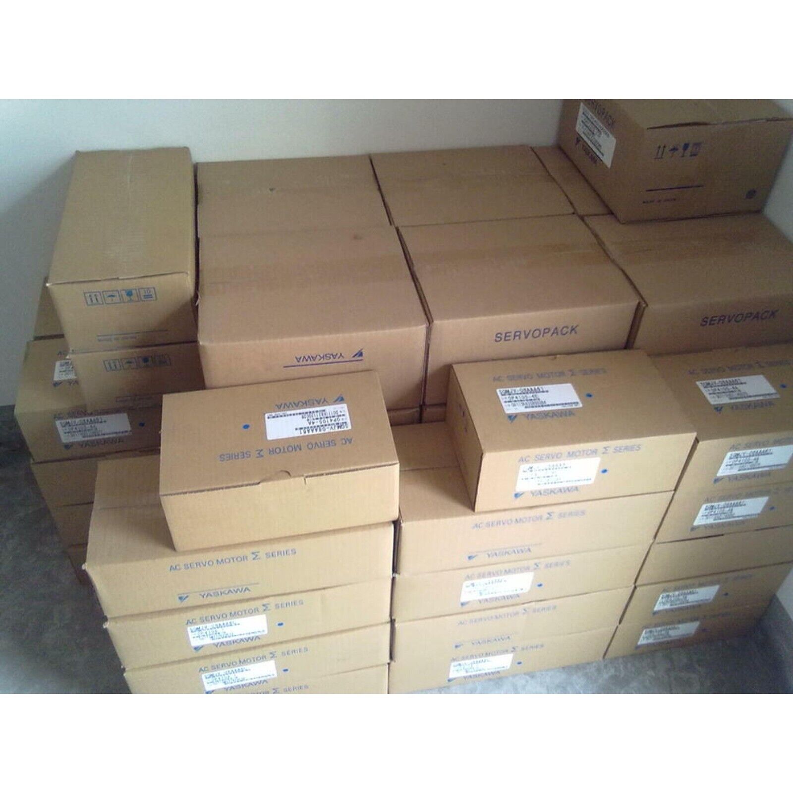 YASKAWA AC Servo Motors in boxes, ready for expedited shipping. Industrial automation parts.