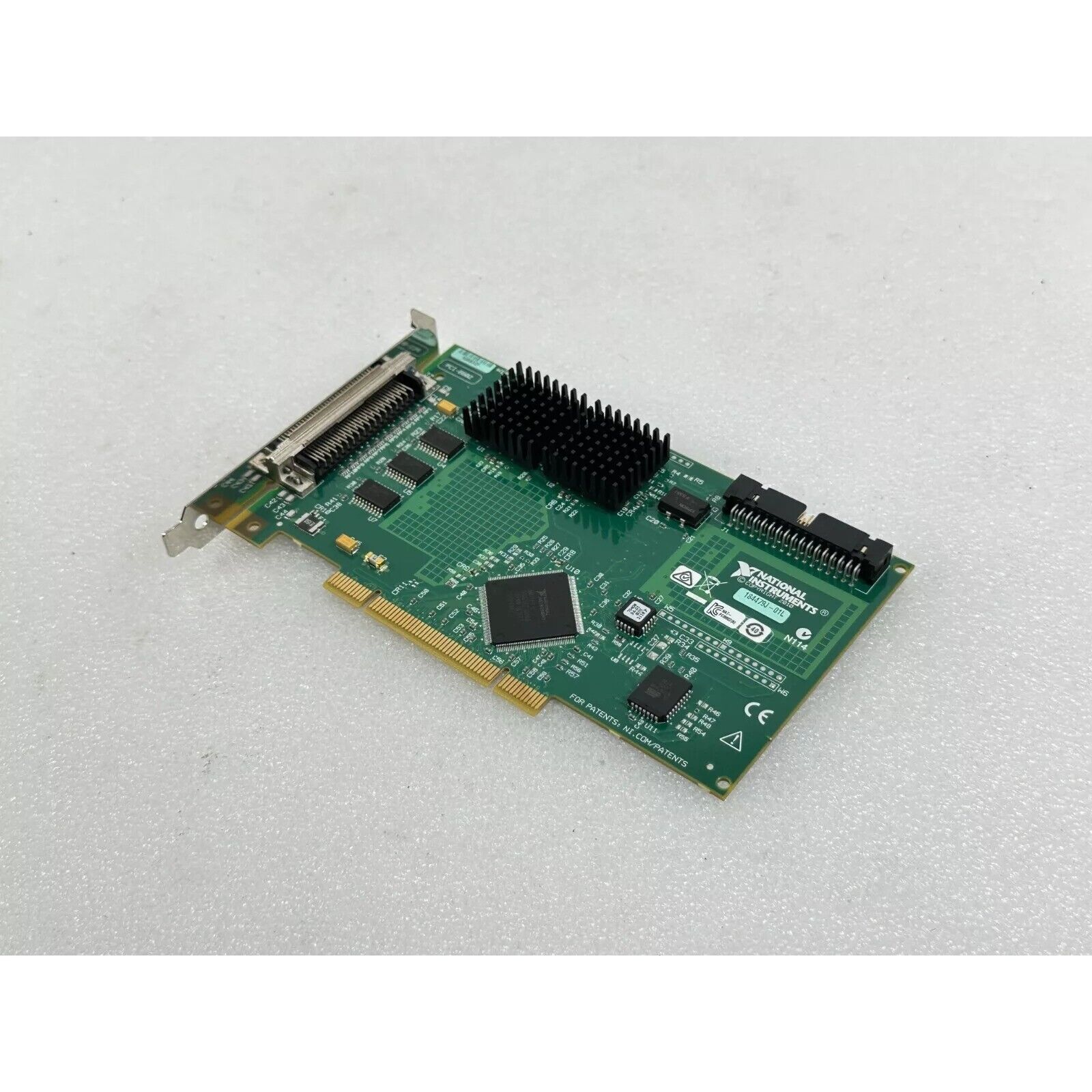 National Instruments PCI-6602 data acquisition card, green circuit board with black heat sink, for industrial automation.