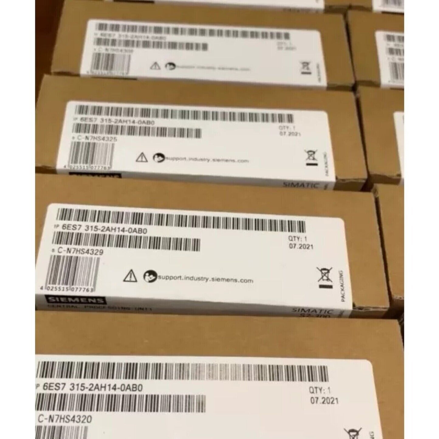 Siemens SIMATIC S7-300 CPU 6ES7315-2AH14-0AB0 boxes, industrial automation parts, packaging.