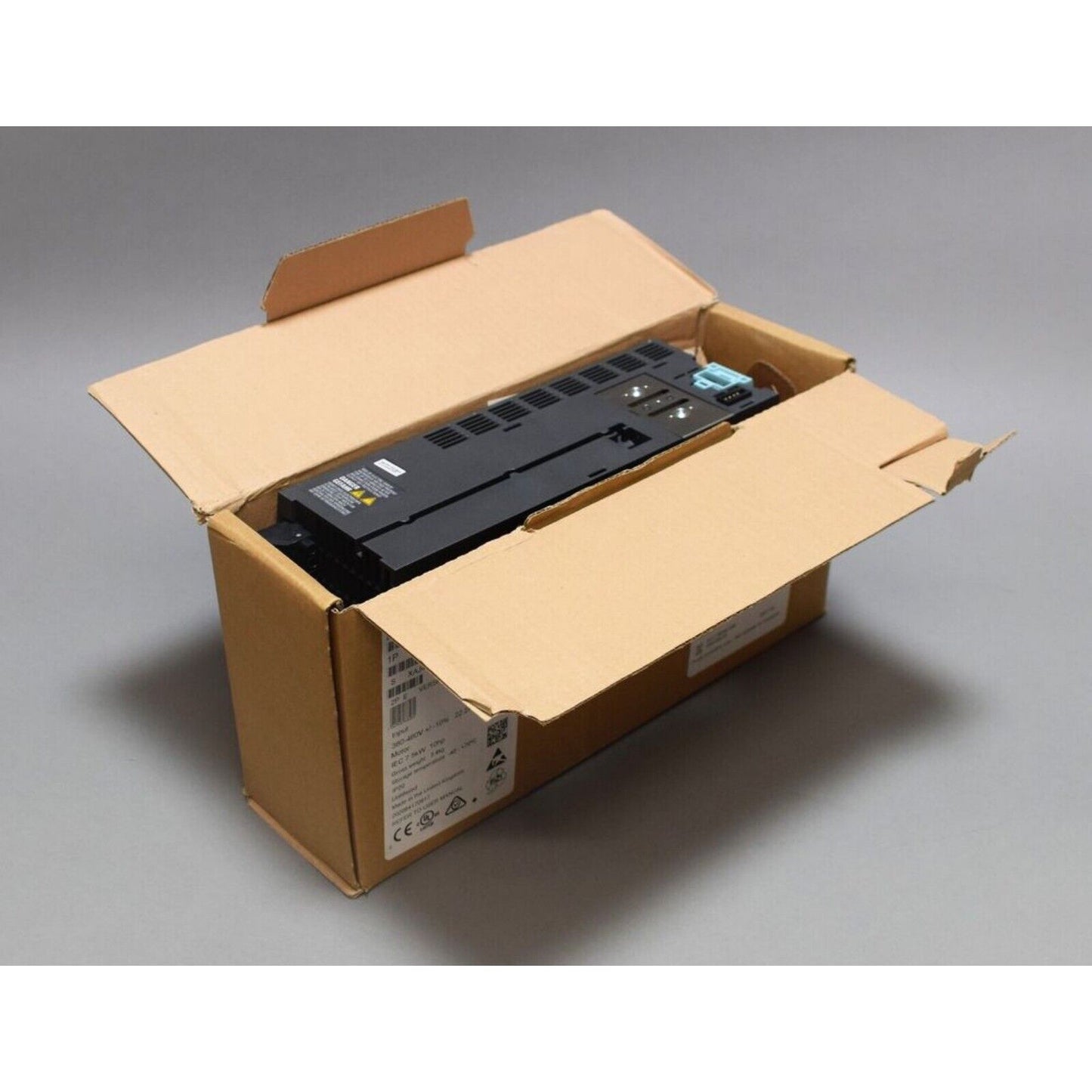 Siemens SINAMICS G120C frequency inverter in a cardboard box, industrial automation equipment.