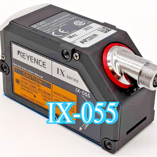 Keyence IX-055 Laser Sensor, black and gray industrial sensor with red accents, featuring product information and warnings.