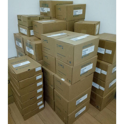 YASKAWA SGDV-2R8A11B002000 Servo Drive boxes in a warehouse, stacked, ready for shipment. SERVOPACK label visible.