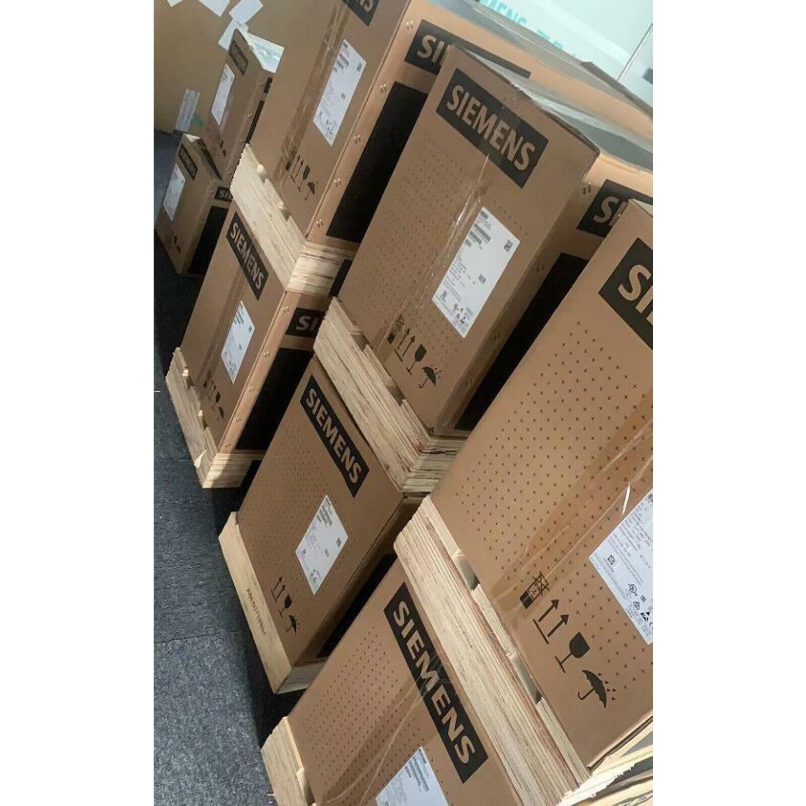 Siemens SINAMICS G120C power modules stacked on pallets, industrial automation parts