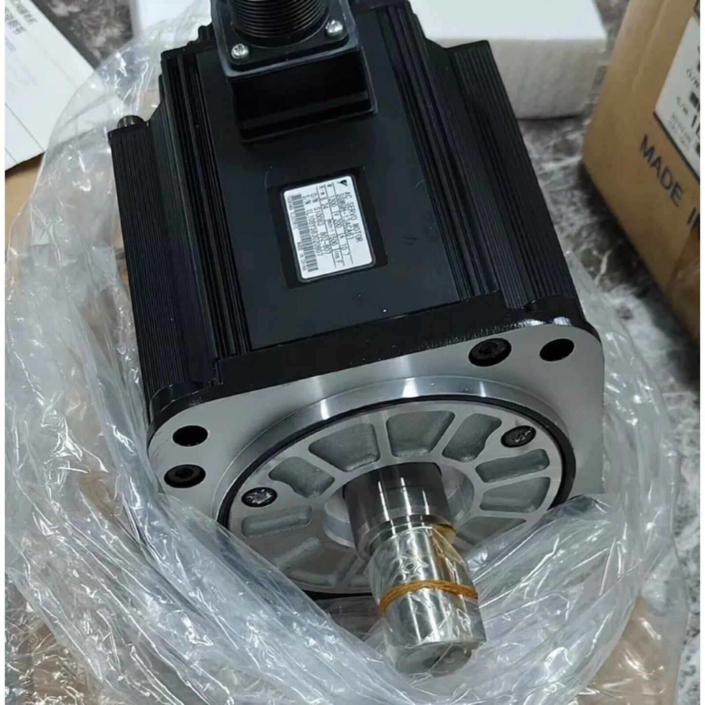 Yaskawa SGMGH-13ACA61 servo motor in package. Black industrial automation part, made in China. With model and serial info.