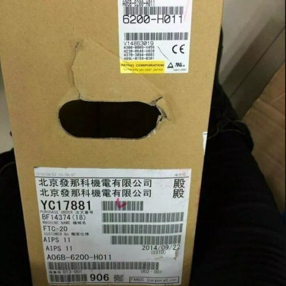 FANUC A06B-6200-H011 Servo Drive packaging with labels, part numbers and CE mark. Includes 'Beijing FANUC Electric' and date.