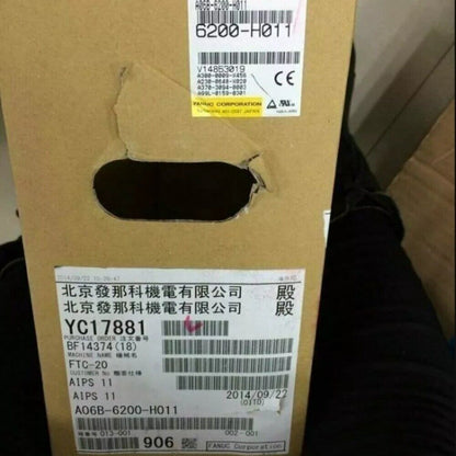 FANUC A06B-6200-H011 Servo Drive packaging with labels, part numbers and CE mark. Includes 'Beijing FANUC Electric' and date.