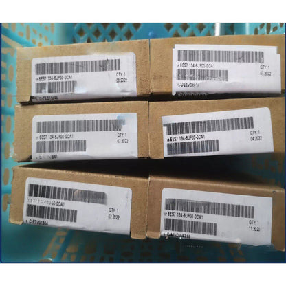 Siemens SIMATIC ET 200SP 6ES7134-6JF00-0CA1 modules in boxes, with product labels and barcodes, for industrial automation.