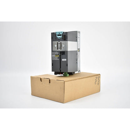 Siemens SINAMICS PM240-2 power module, model 6SL3210-1PB13-0AL0, industrial automation part in box, danger sign visible.