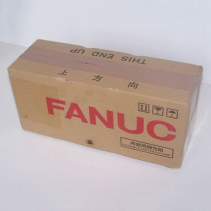 FANUC servo motor packaging, brown cardboard box, 'THIS END UP' label