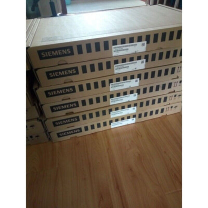 Stacked Siemens PLC modules in cardboard boxes, ready for shipment.