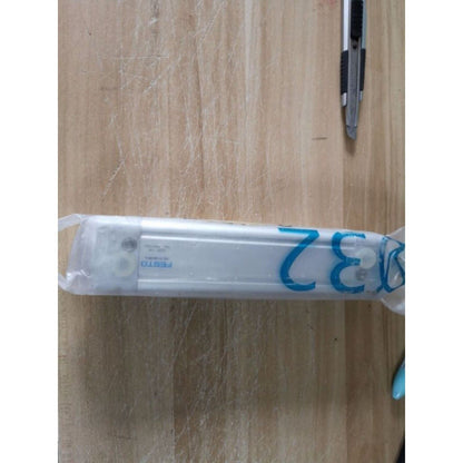 FESTO DNC-32-100-PPV-A pneumatic cylinder on wooden surface