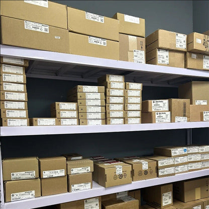 Warehouse stock of PLC components, Siemens automation parts in boxes on shelves, industrial automation.