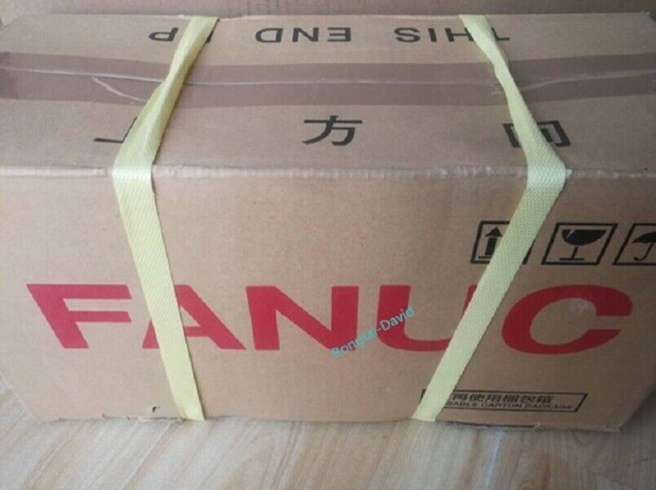 FANUC A06B-2202-B805 servo motor box packaging with straps, industrial automation part