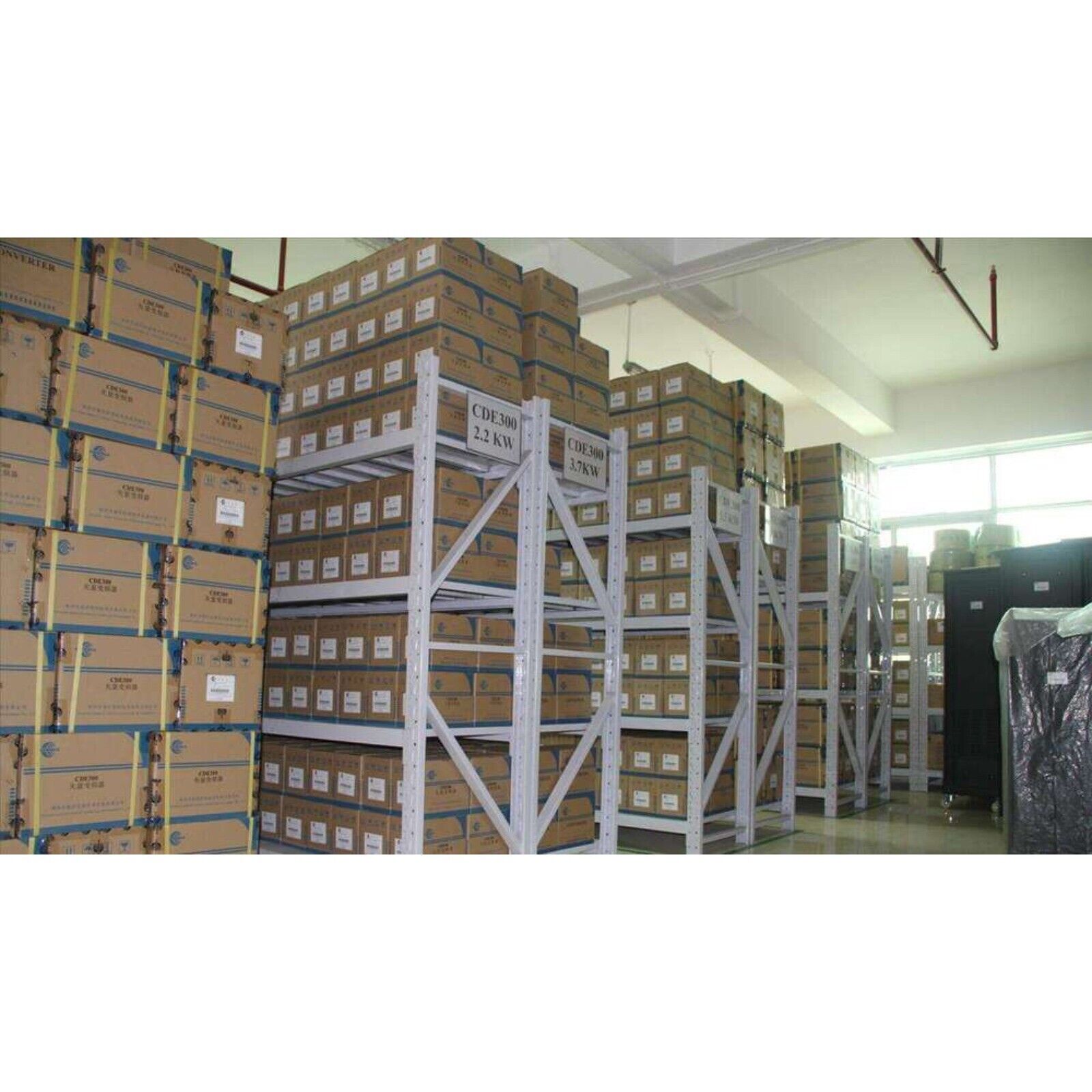 Warehouse storage of automation parts, including CDE300 2.2KW and 3.7KW models, ready for shipment.