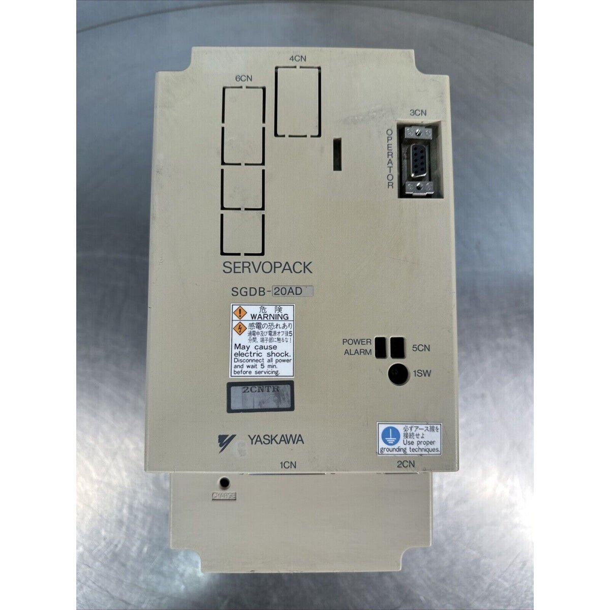 YASKAWA ServoPack SGDB-20AD servo drive, beige industrial automation equipment. Features warning labels and connection ports.