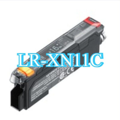 Keyence LR-XN11C Laser Sensor Amplifier, black and clear plastic housing with orange indicator light, new product.