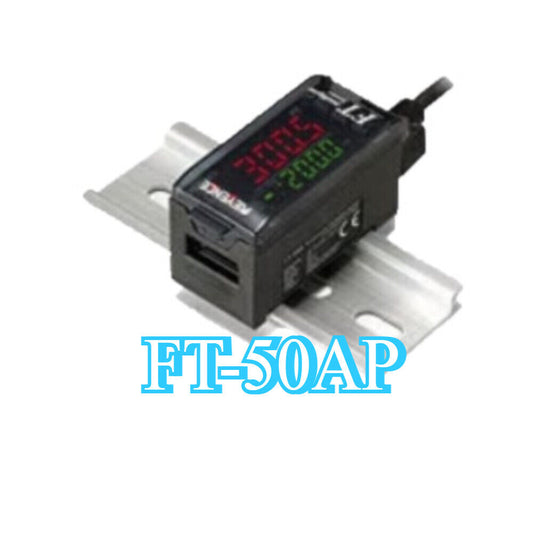 Keyence FT-50AP Temperature Sensor Amplifier, black device displaying readings, mounted on a metal rail.