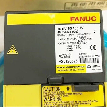 FANUC A06B-6124-H209 servo drive, industrial automation part, with safety warnings.