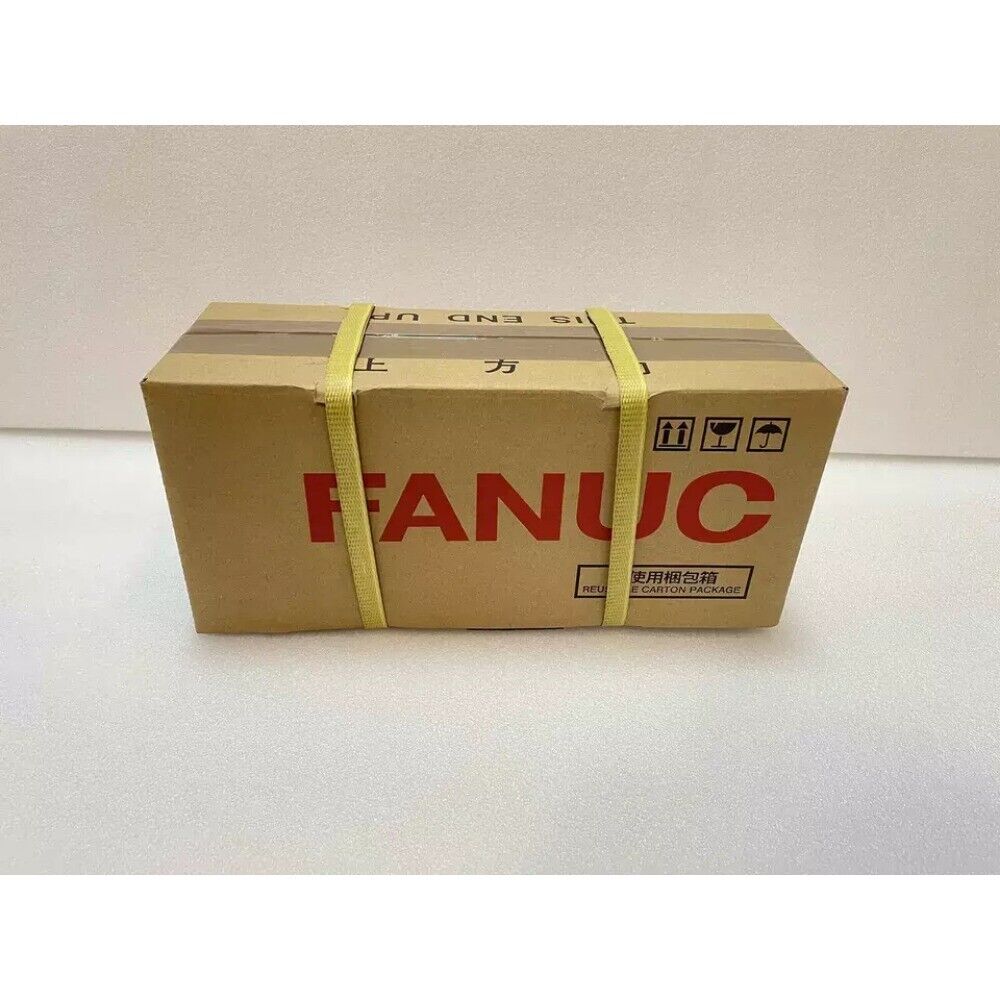 FANUC A06B-0227-B100 Servo Motor in a cardboard box, ready for shipping, new industrial automation part.
