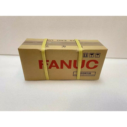 FANUC A06B-0227-B100 Servo Motor in a cardboard box, ready for shipping, new industrial automation part.