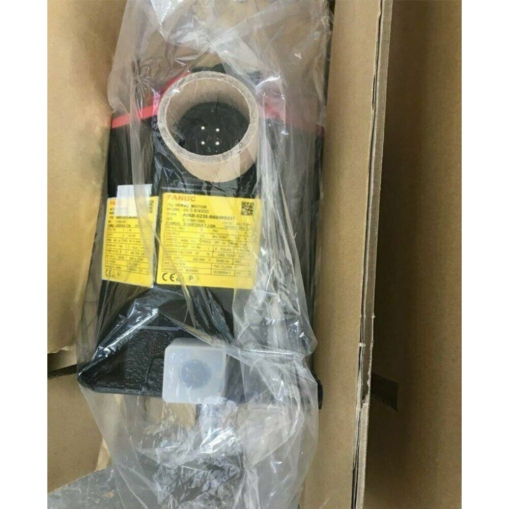 FANUC A06B-0235-B605#S037 servo motor, packaged in plastic, with label visible inside a cardboard box.