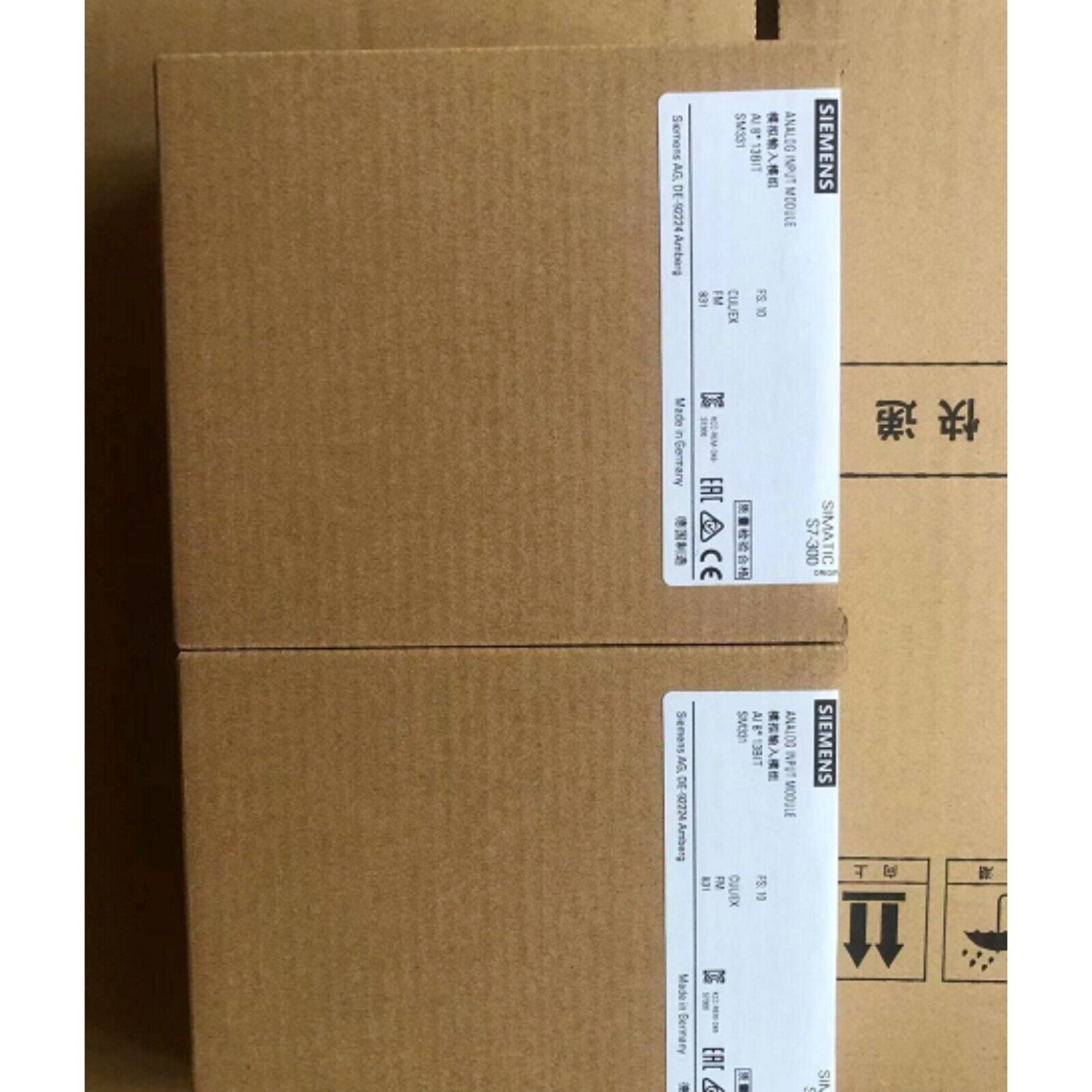 Two boxes of Siemens SIMATIC S7-300 Analog Input Module, product packaging.