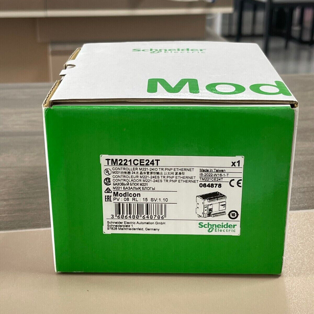 Schneider Electric TM221CE24T PLC Controller - Box showing controller model, product information, and Modicon branding.