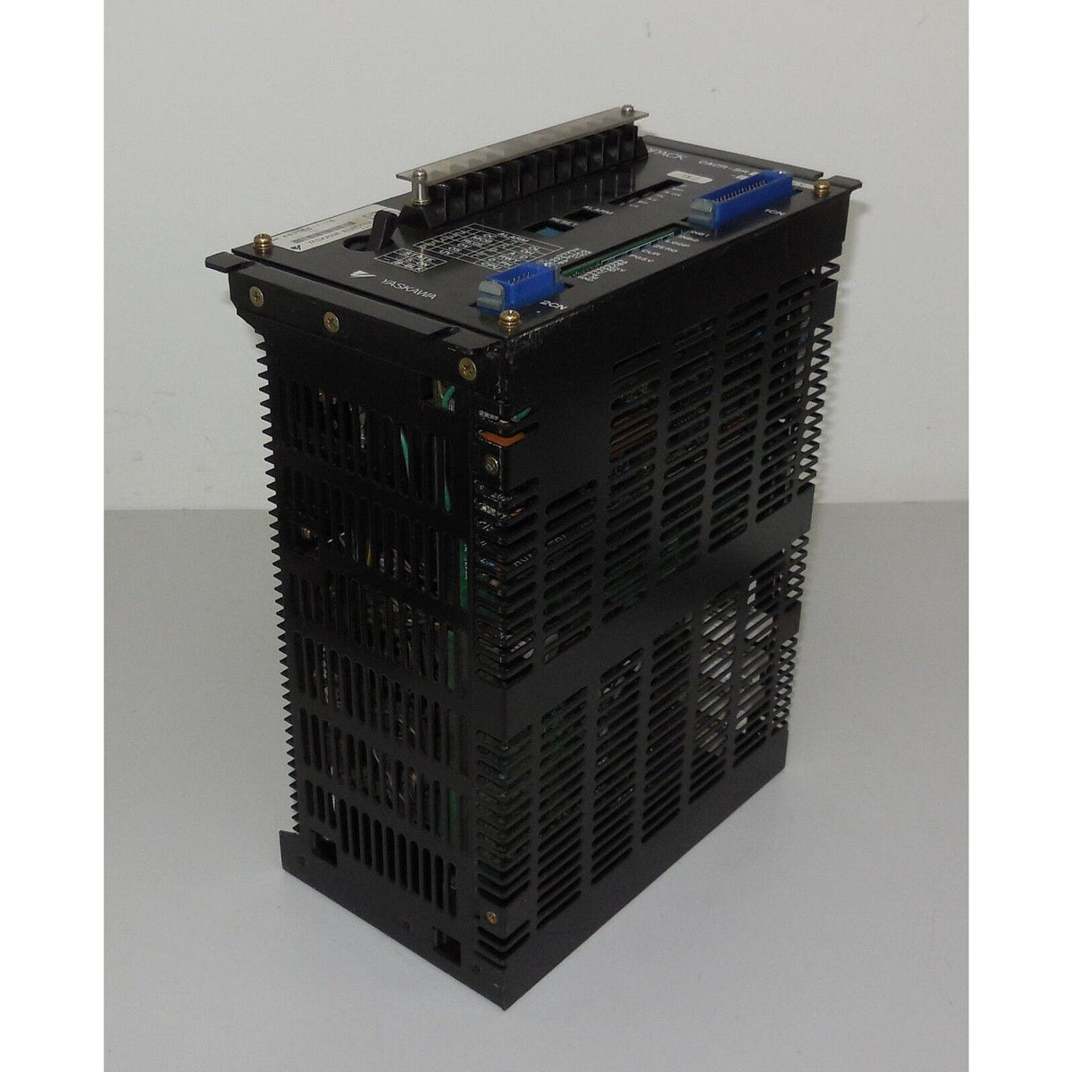 Yaskawa servopack CACR-SR05BC1ES-Y278 servo drive. Black metal enclosure, multiple ports and cooling fins.