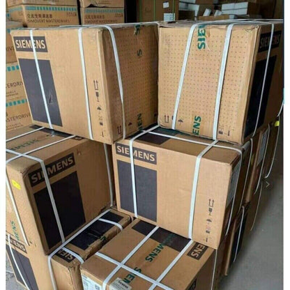 Siemens industrial automation equipment boxes, stacked and strapped, displaying the Siemens logo.