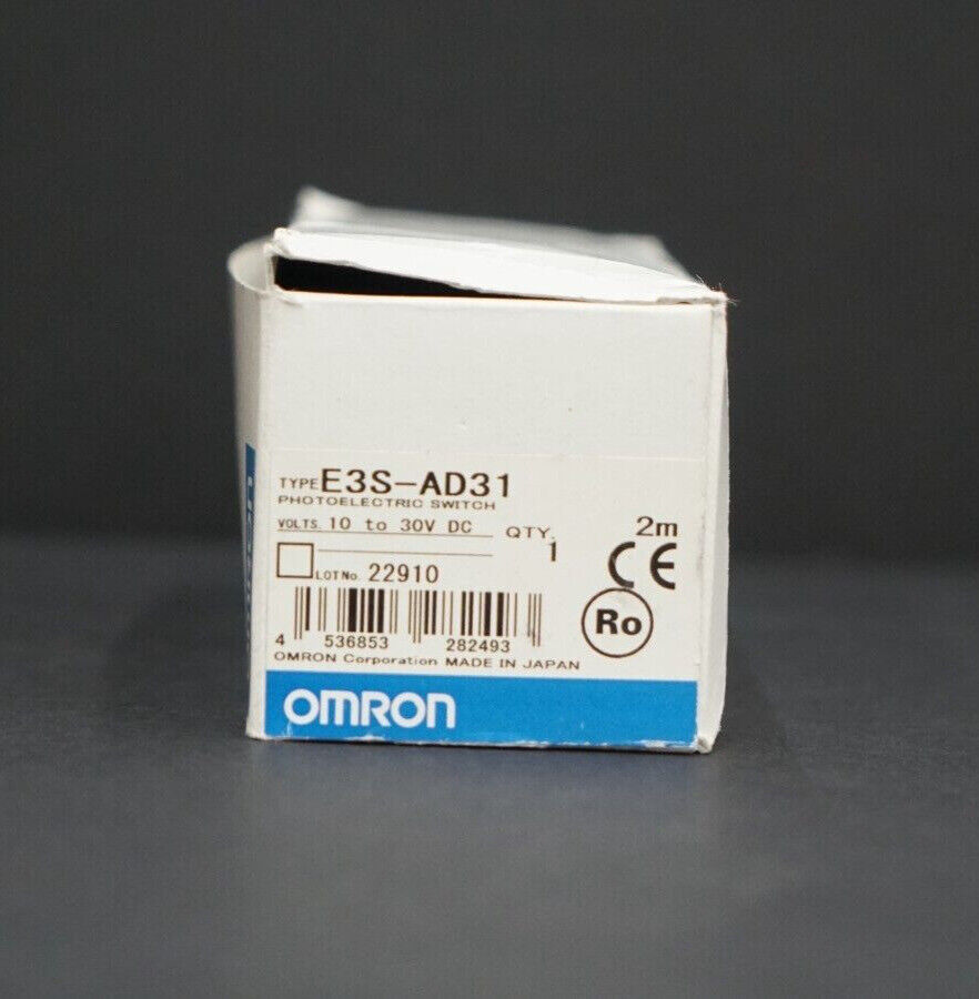 Omron E3S-AD31 photoelectric sensor box, labeled with product details, including voltage, quantity, and certification logos. 