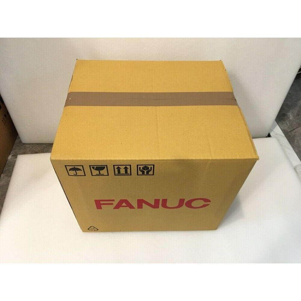 FANUC PLC module packaged in a brown cardboard box. Industrial automation part, fast shipping.