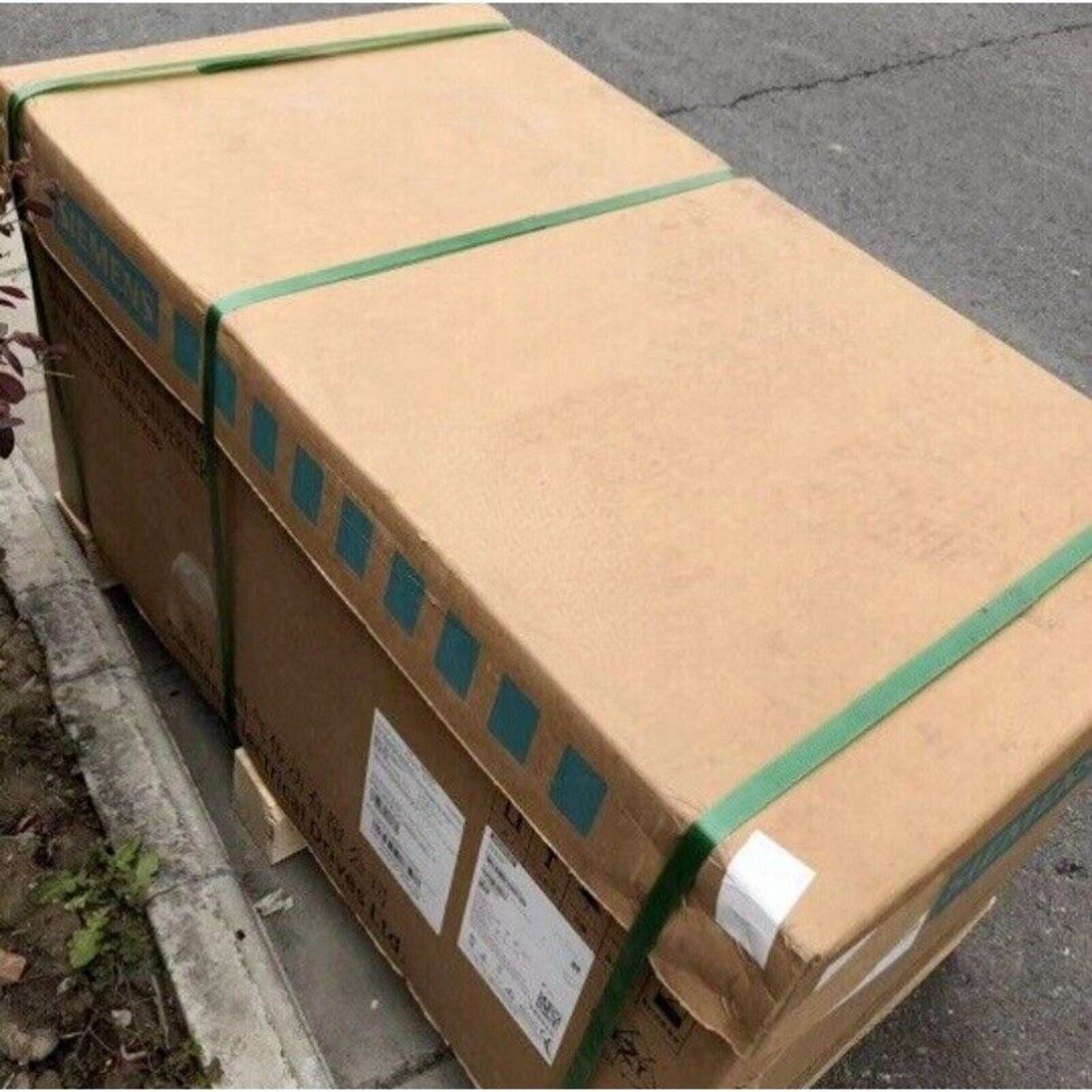 Siemens MICROMASTER 440 drive in a cardboard box secured with green straps, Industrial Automation Parts.