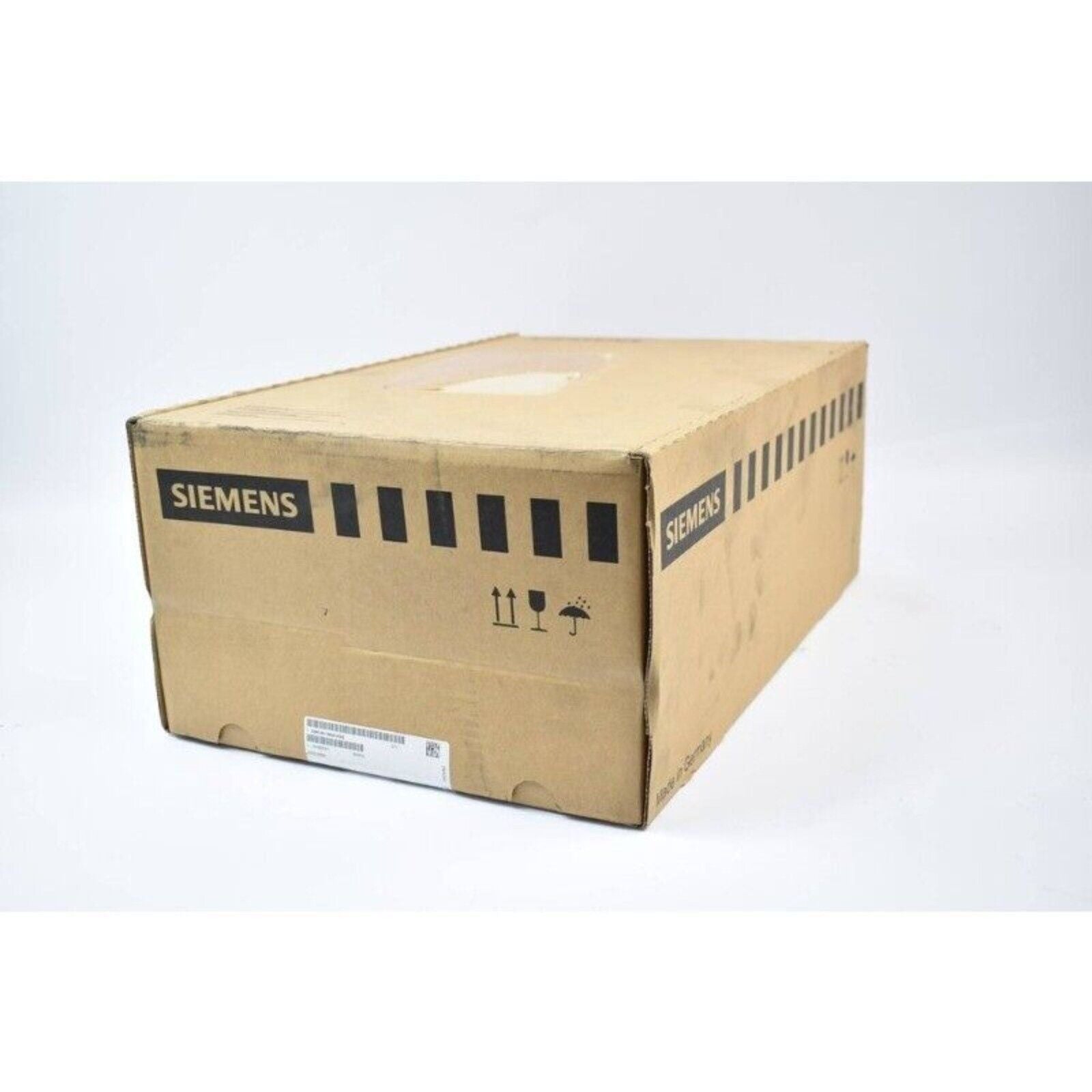 Siemens industrial automation part in a brown cardboard box, Made in Germany, shipping symbols.