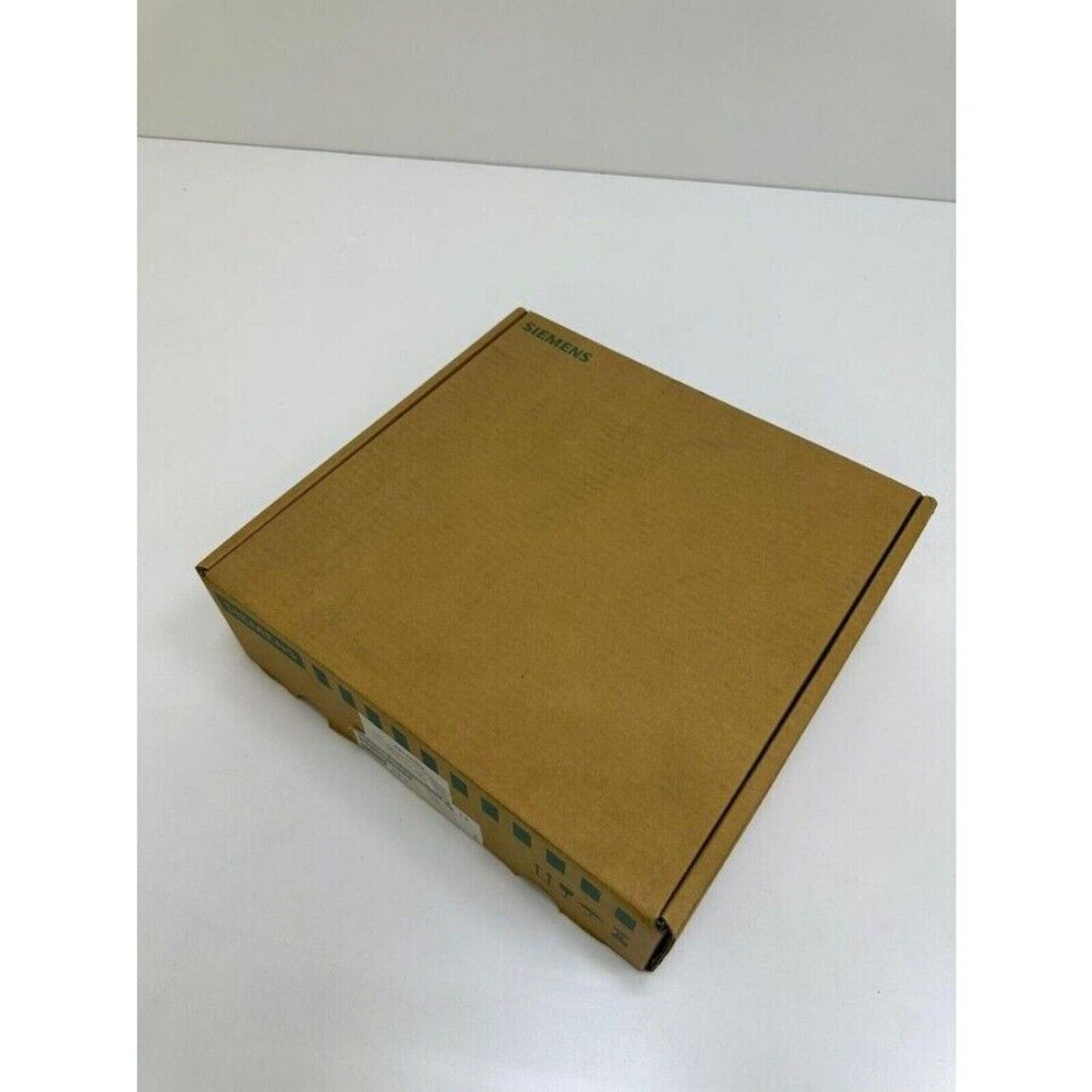 Siemens SINUMERIK industrial part packaging box, brown cardboard, Siemens logo visible.