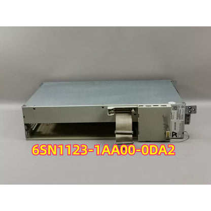 SIMODRIVE 611 6SN1123-1AA00-0DA2 power module. Industrial automation part, metal casing, cable and connector.