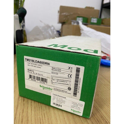 Schneider Electric Modicon TM218LDA60DRN Programmable Logic Controller module in green box, industrial automation part.