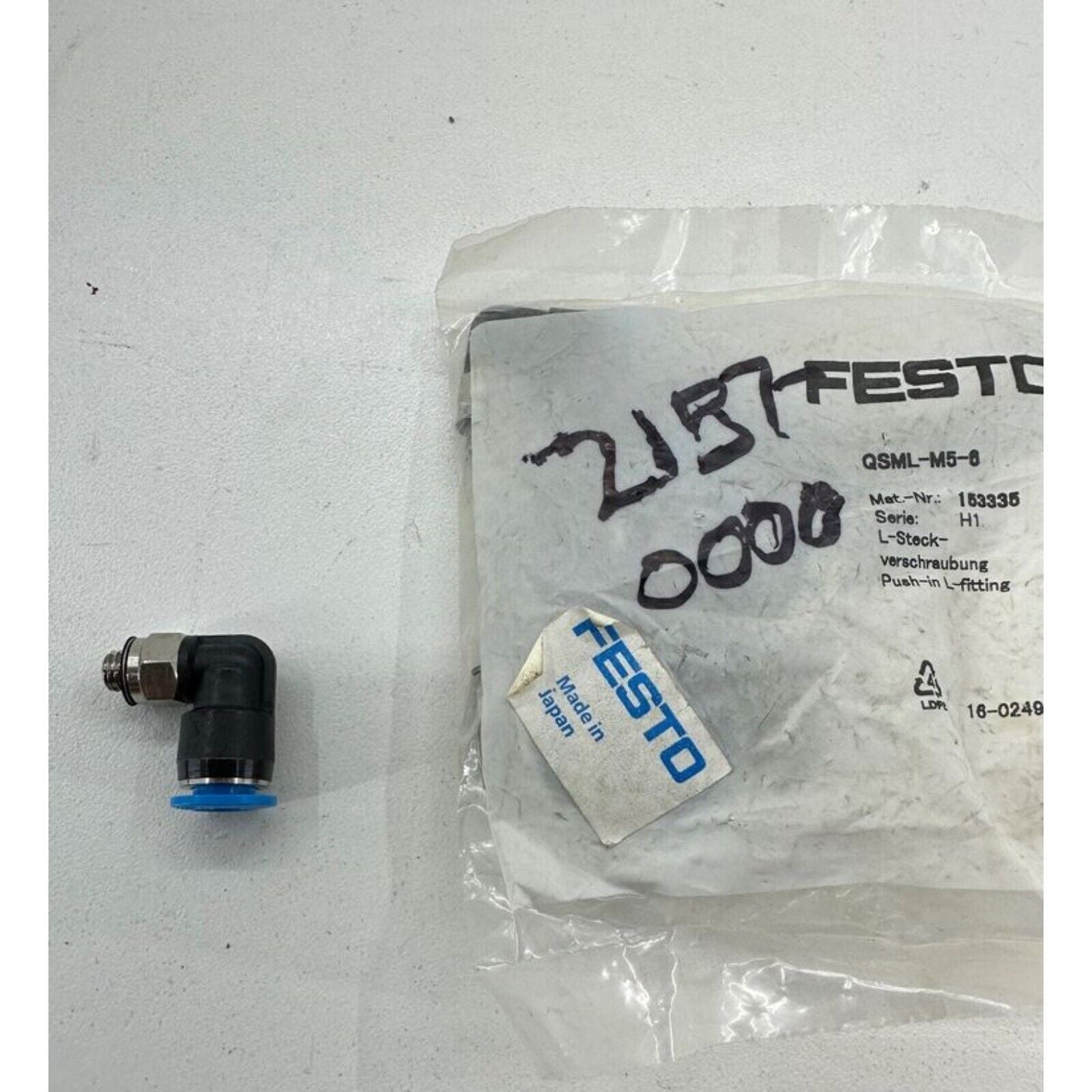 Festo QSML-M5-6 L-fitting pneumatic component, Made in Japan, with blue accents, black body and silver connector.