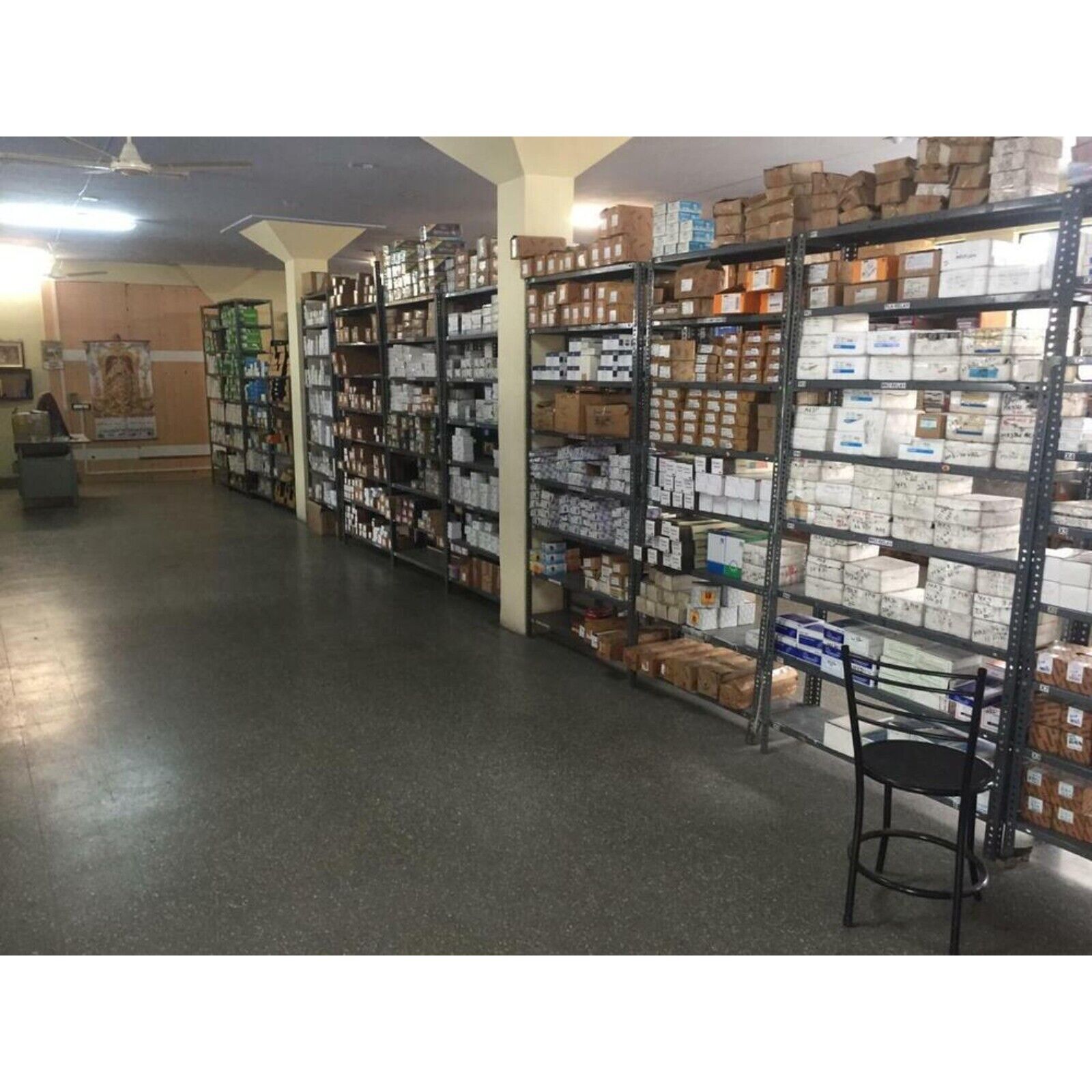 Warehouse of industrial automation components, with shelves full of boxes, showcasing a wide inventory of parts.