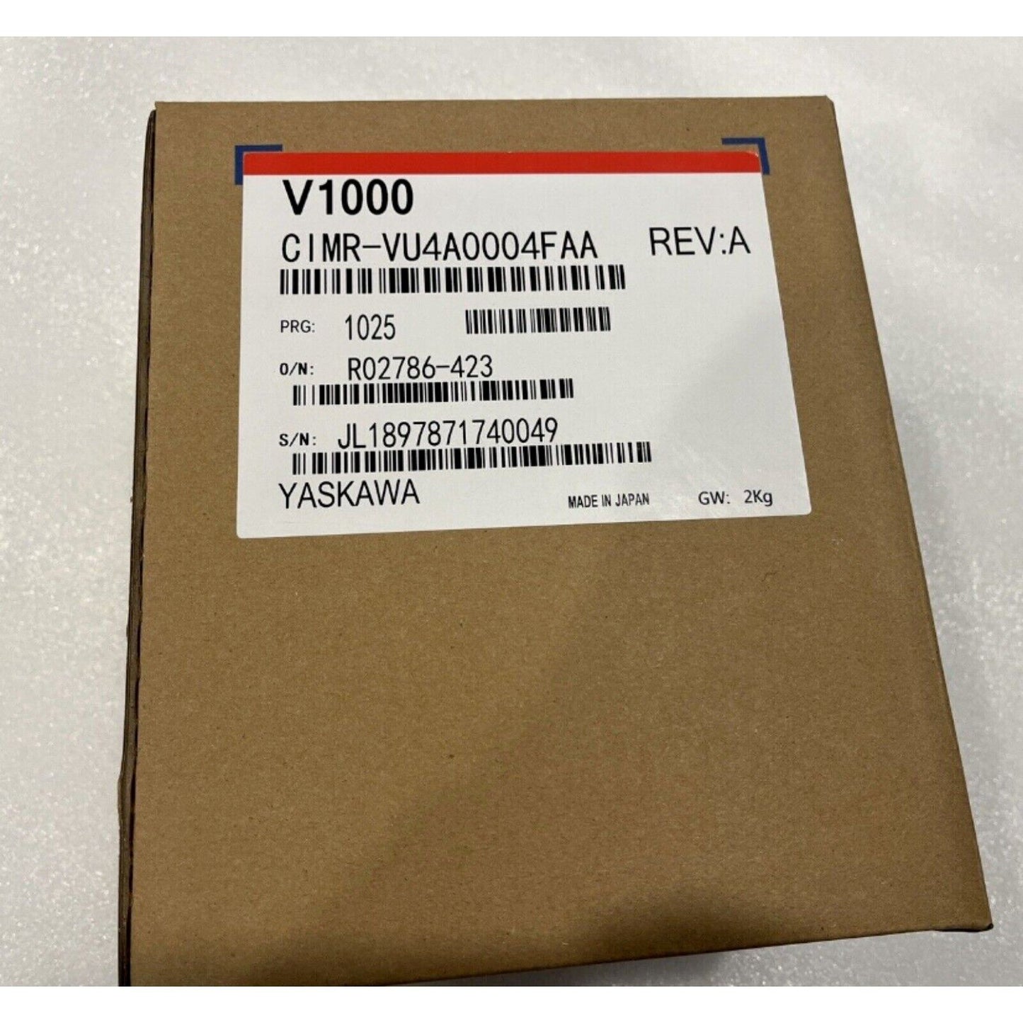 YASKAWA CIMR-VU4A0004FAA Inverter on a cardboard box. New industrial automation part with model information visible.