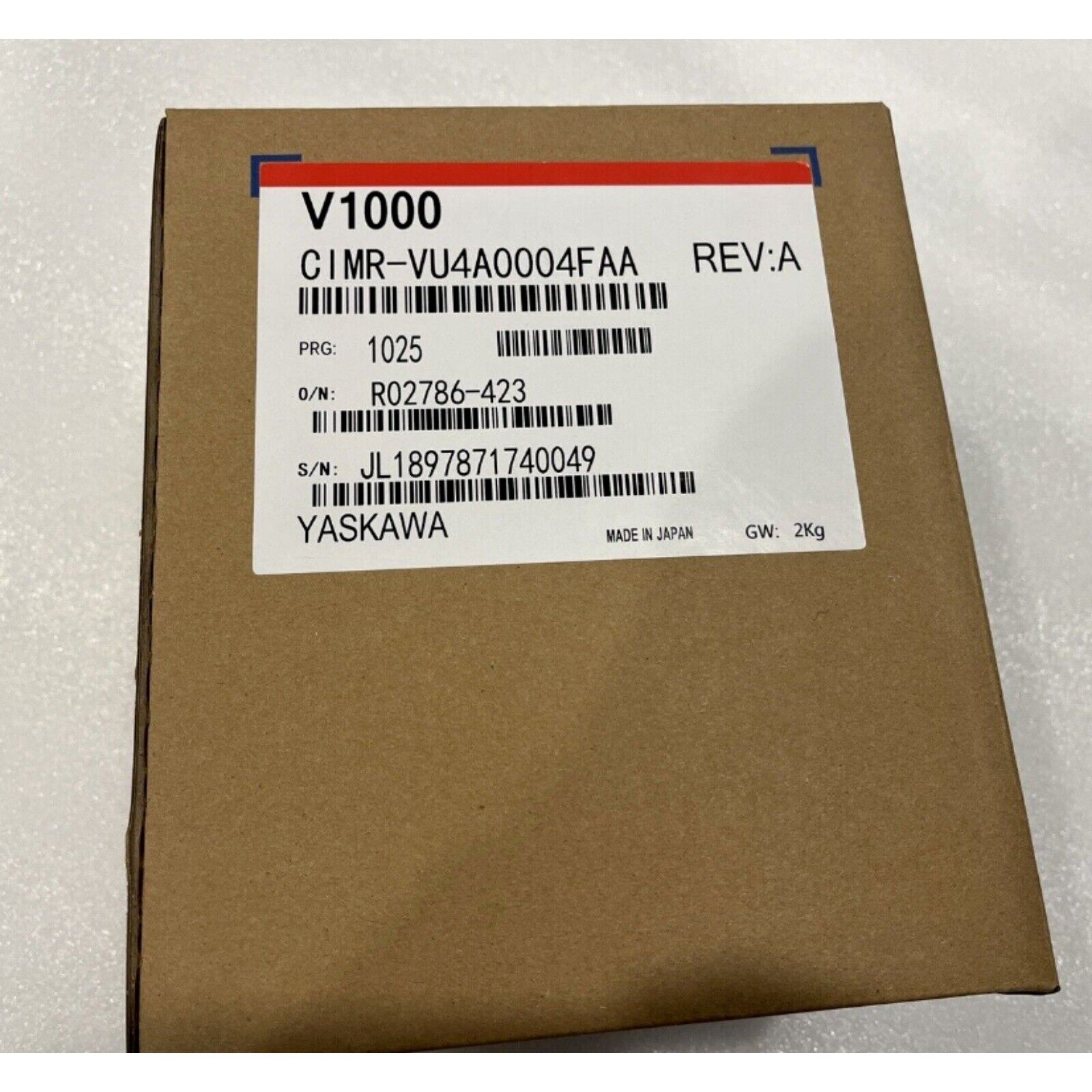 YASKAWA CIMR-VU4A0004FAA Inverter on a cardboard box. New industrial automation part with model information visible.