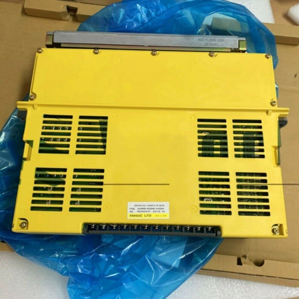 FANUC A06B-6066-H004 Servo Amplifier. Yellow industrial equipment with vent design and text.