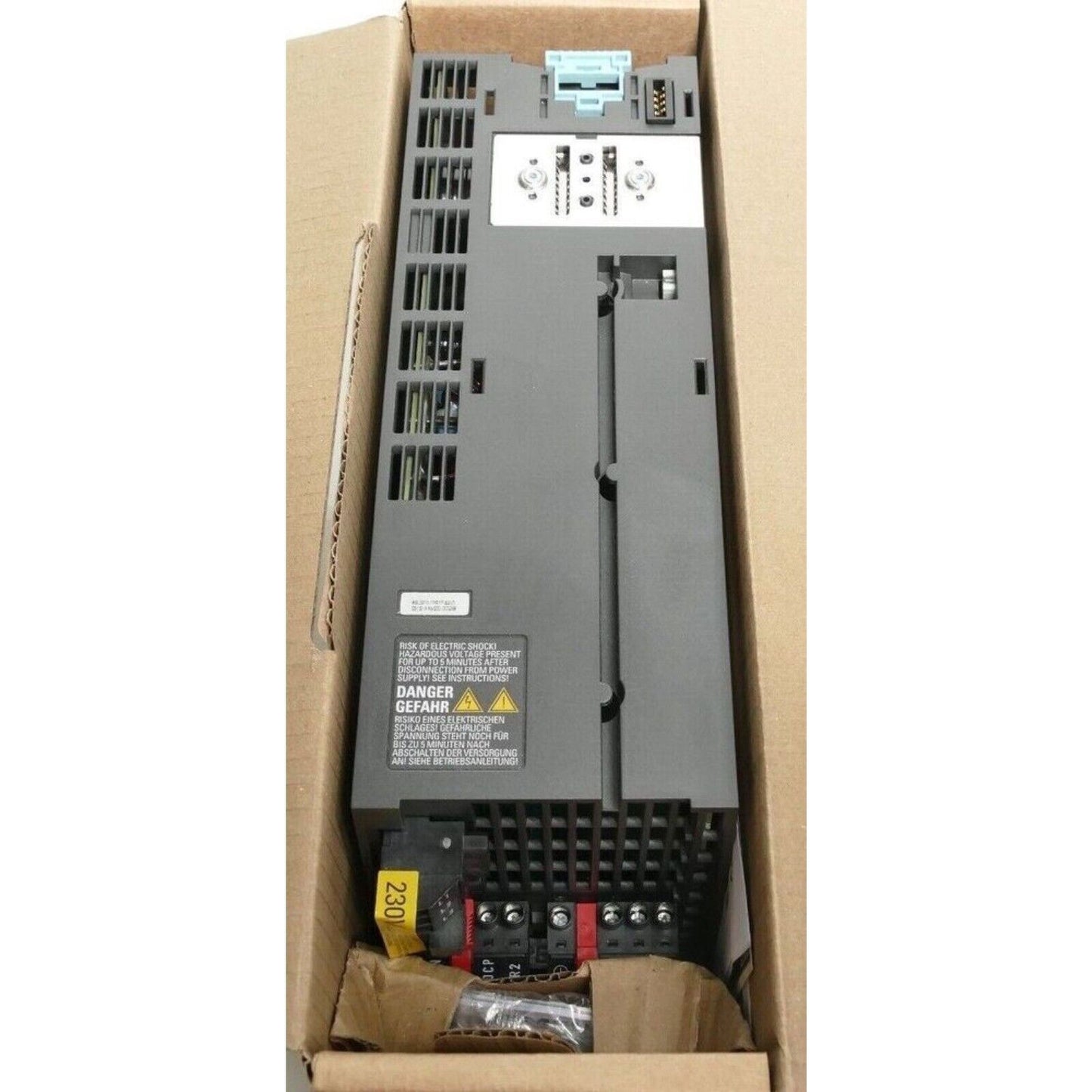 Siemens SINAMICS PM240-2 Power Module in Box. Grey industrial automation part with safety warnings.