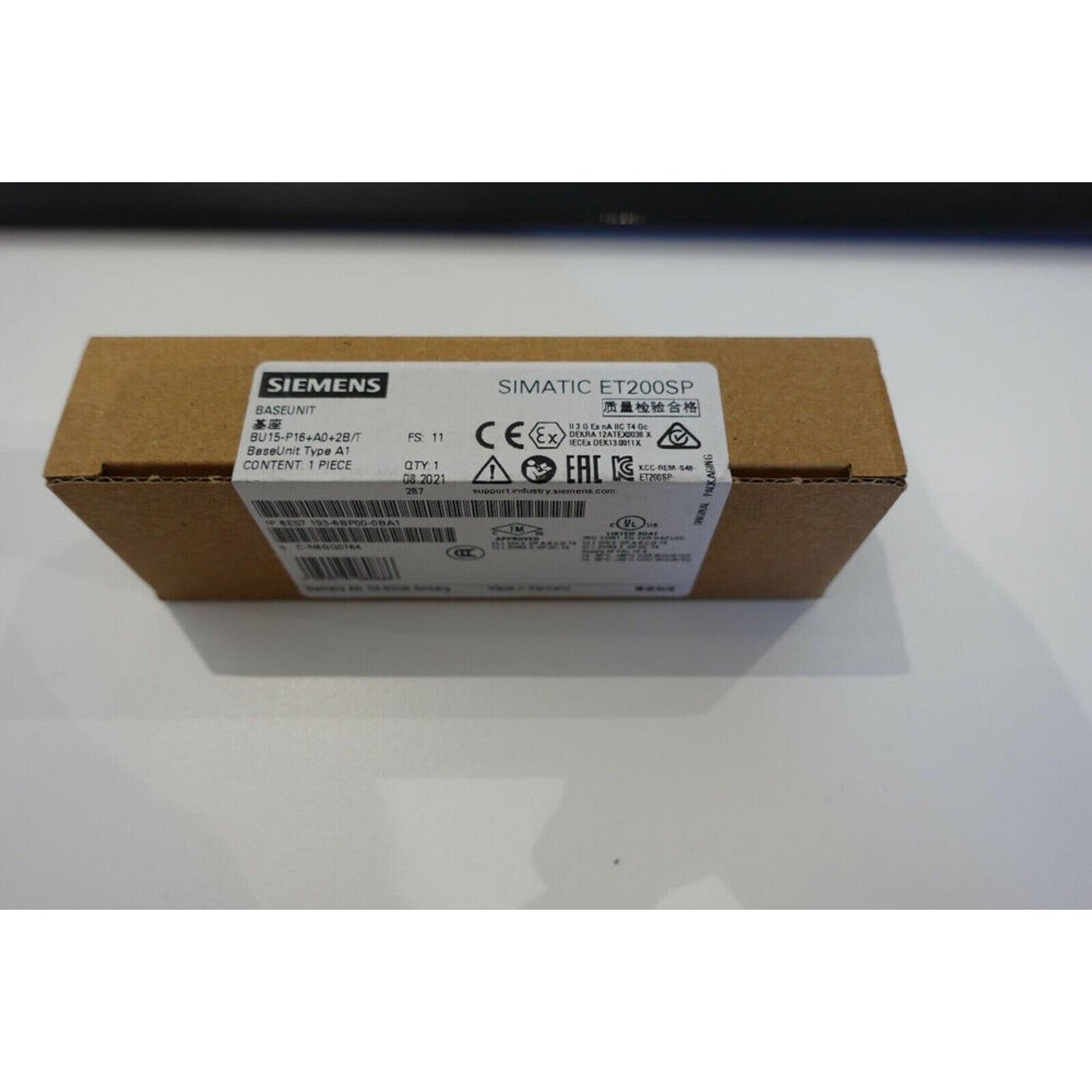Siemens SIMATIC ET200SP BaseUnit A1 packaging, industrial automation part with quality inspection seal.