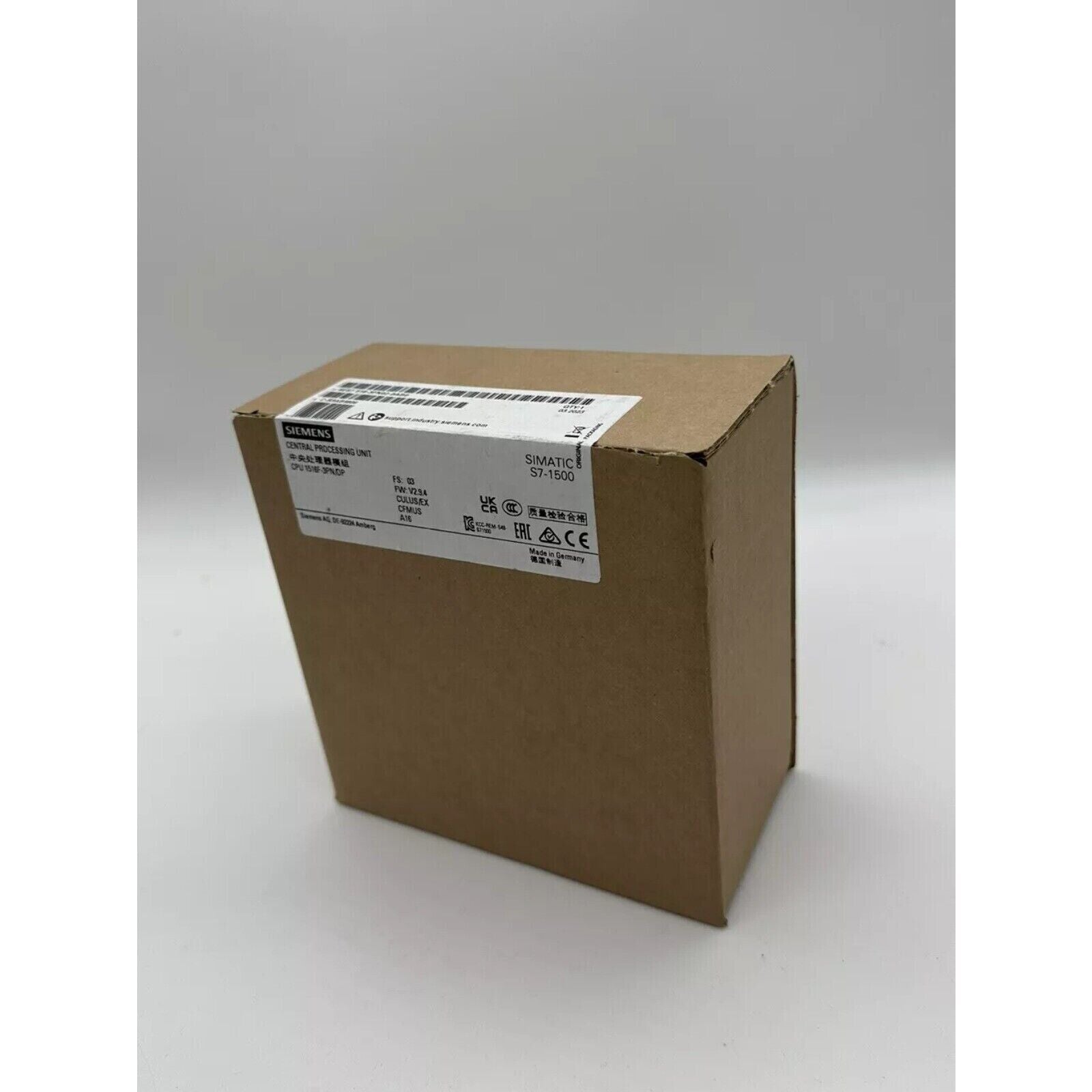 Siemens SIMATIC S7-1500 CPU in a cardboard box, featuring product details and quality certification.