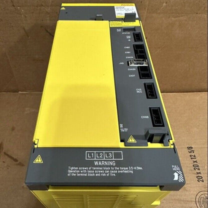 FANUC Power Supply A06B-6202-H026 - Yellow and gray industrial automation component, warning label.
