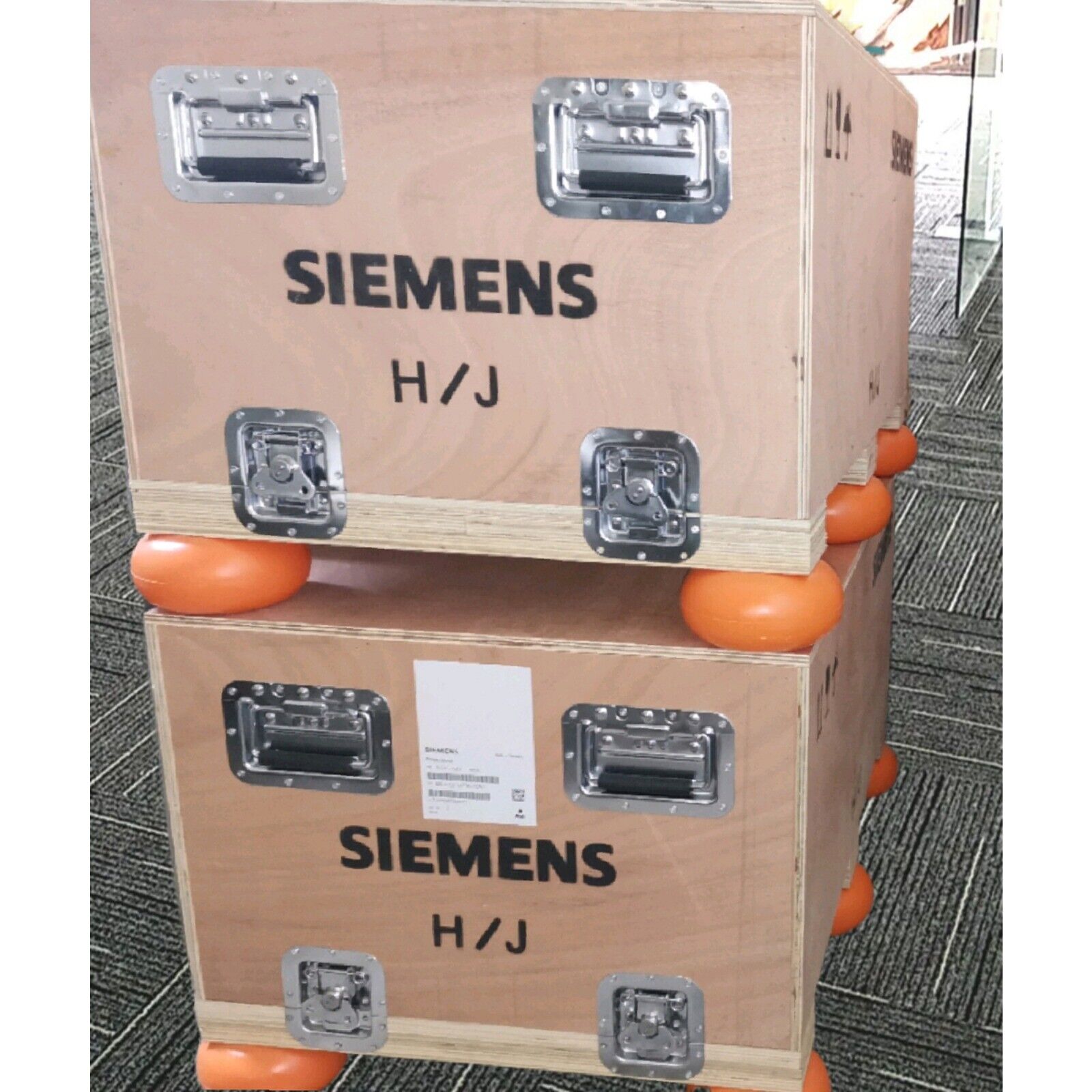 Siemens industrial equipment boxes, wood and metal, stacked for shipping and storage, H/J