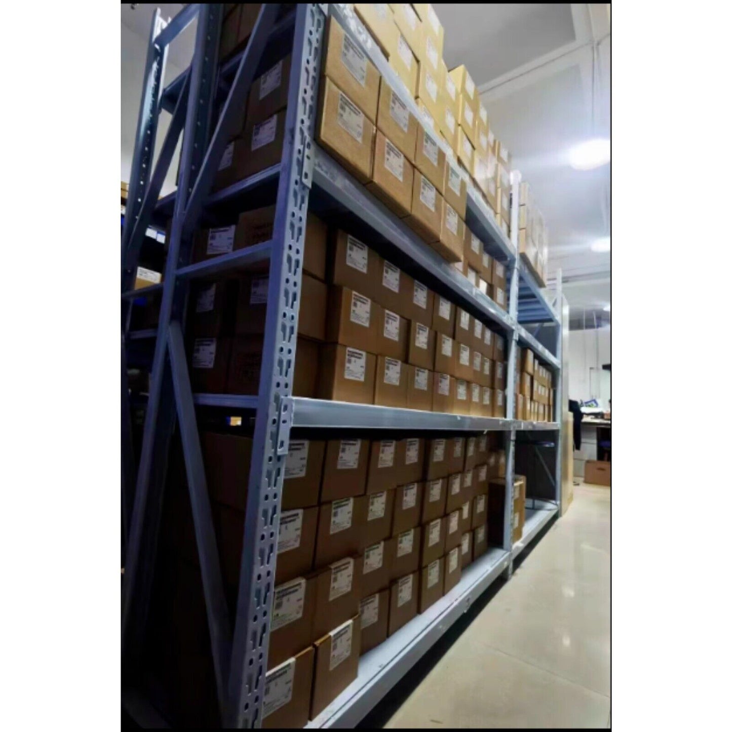 Warehouse shelves filled with Siemens industrial automation parts in boxes, ready for shipment. Automation equipment.